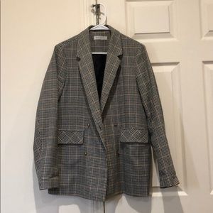 Blazer with a green and beige checkered pattern.